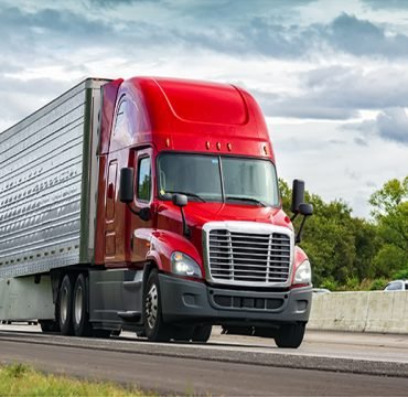 Red Truck on Interstate Highway Horizontal shot of a red semi-truck on an interstate highway.